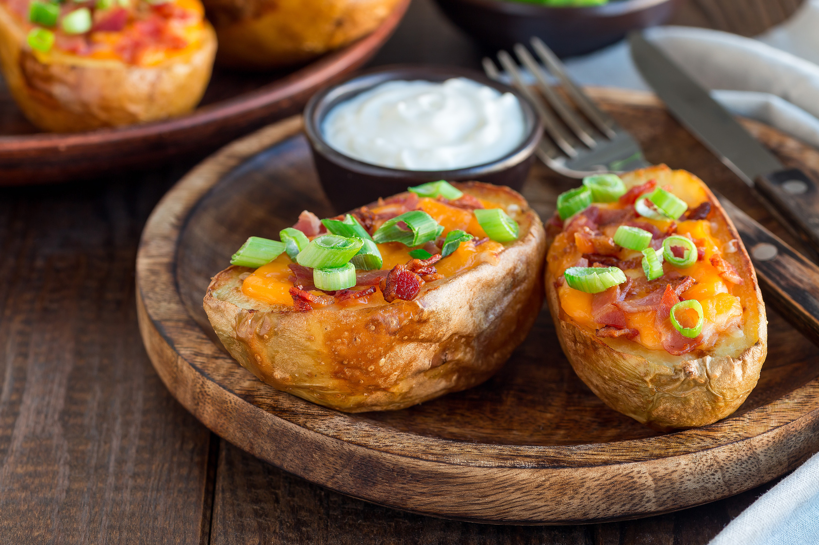 Food inspiration: potato halves filled with cheese and bacon, topped with spring onion
