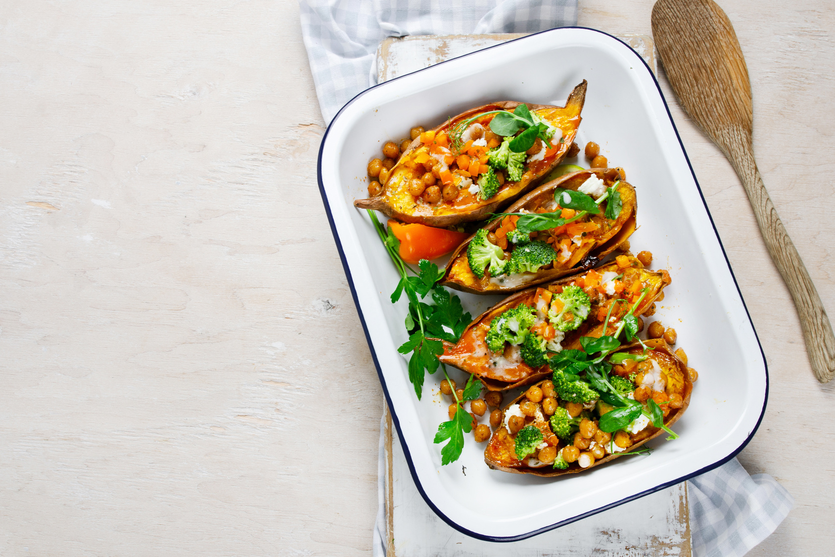Food inspiration: roasted sweet potato boats filled with chickpeas, vegetables and dressing